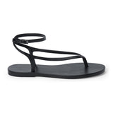 Black leather thong sandal with a minimalist strappy design and adjustable ankle buckle.