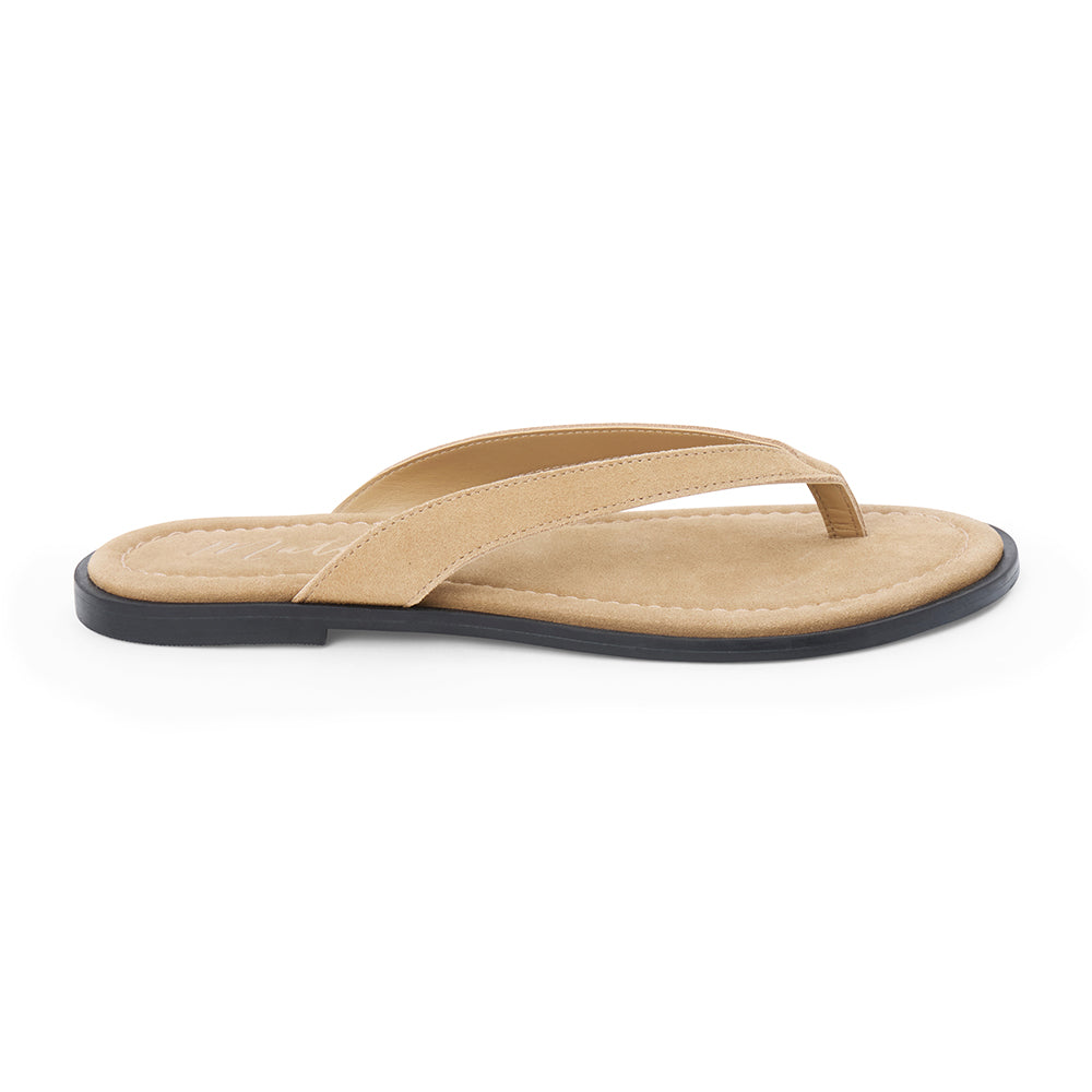 Taupe suede flip flop sandal with cushioned footbed and flat sole, shown on a white background.