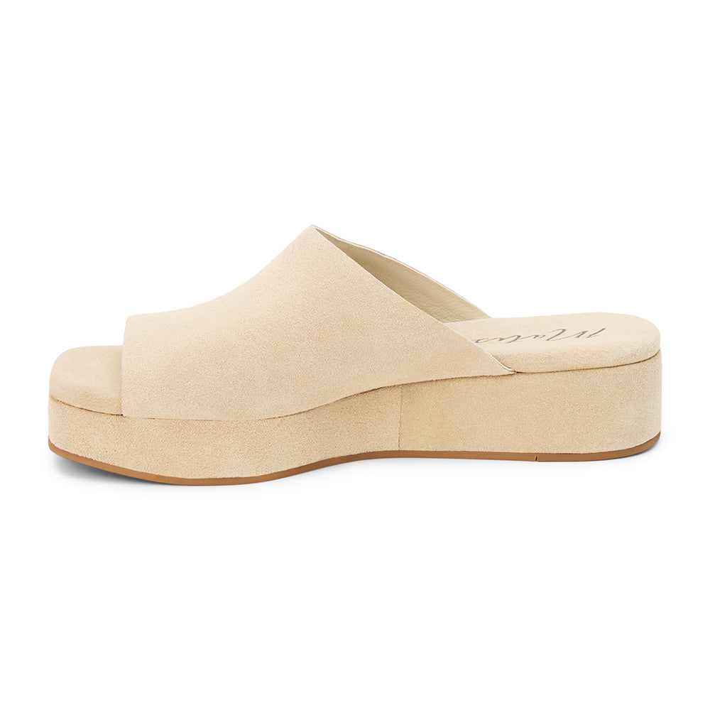 Light beige suede slide sandal with a wide single strap, open toe, platform sole, and slip-on design, shown in side profile on a white background.