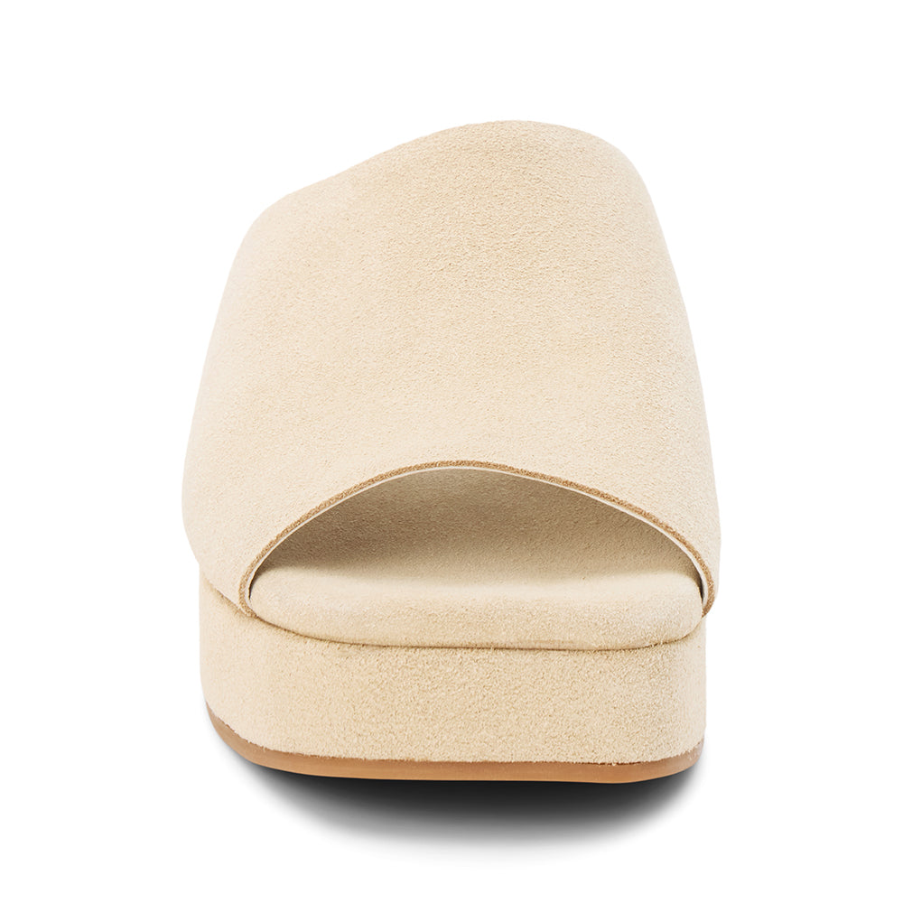 Light beige suede slide sandal with a wide single strap, open toe, platform sole, and slip-on design, shown in side profile on a white background.