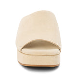 Light beige suede slide sandal with a wide single strap, open toe, platform sole, and slip-on design, shown in side profile on a white background.
