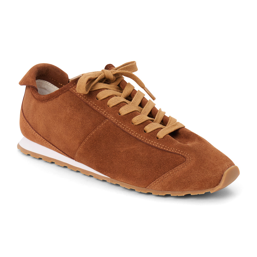 Brown suede trainer with tan laces, tonal paneling, a low-profile silhouette, white midsole, and gum outsole shown on a white background.