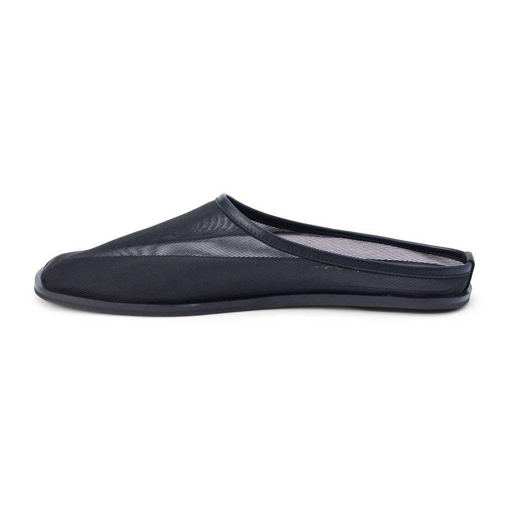 Black mesh slip-on mule with closed toe, open back, low-profile sole, shown in side profile on a white background.
