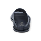 Black mesh slip-on mule with closed toe, open back, low-profile sole, shown in back profile on a white background.