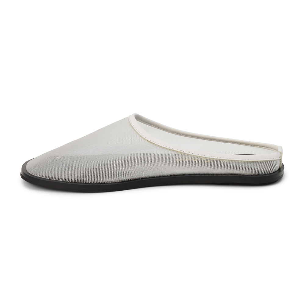 White mesh slip-on mule with closed toe, open back, low-profile sole, shown in side profile on a white background.