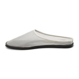 White mesh slip-on mule with closed toe, open back, low-profile sole, shown in side profile on a white background.