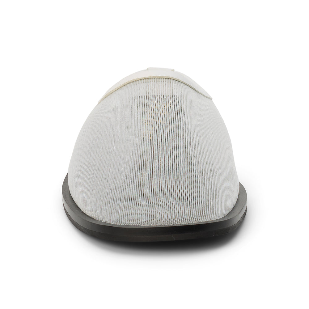 White mesh slip-on mule with closed toe, open back, low-profile sole, shown in front profile on a white background.