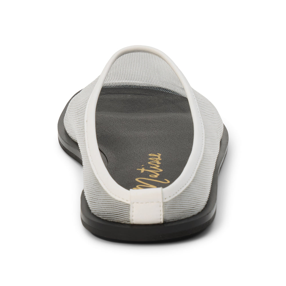 White mesh slip-on mule with closed toe, open back, low-profile sole, shown in back profile on a white background.