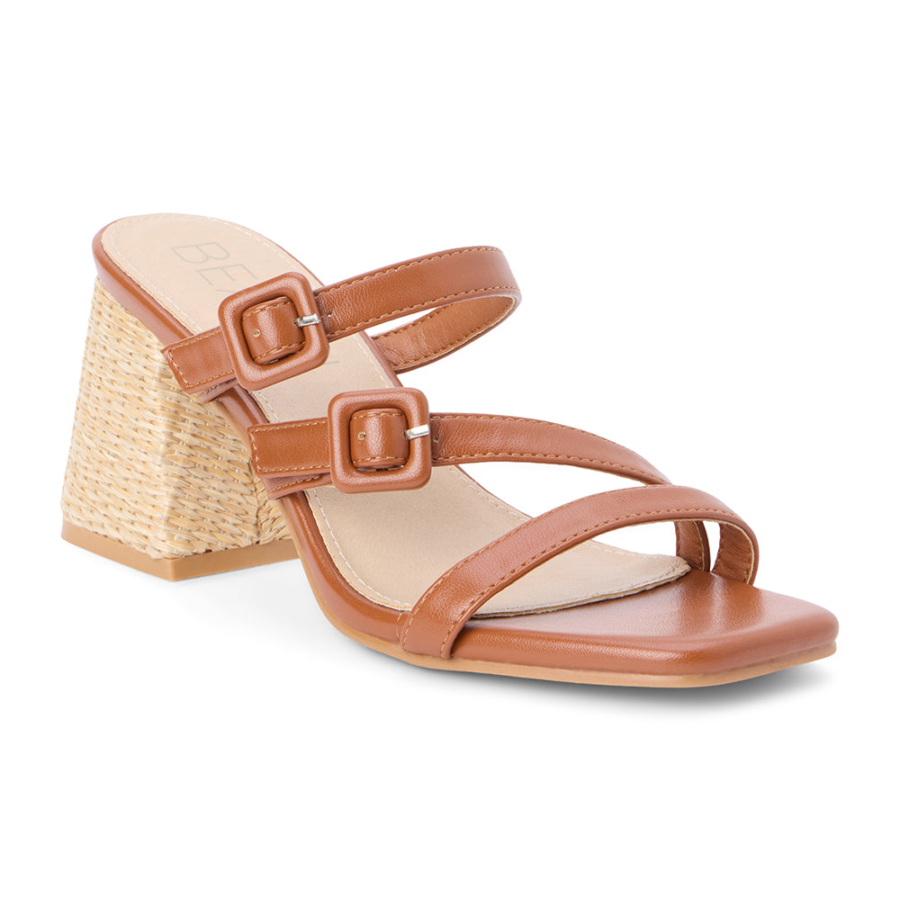 Cognac faux leather sandal with adjustable buckle straps, open square toe, raffia-wrapped block heel, and slip-on design, shown on a white background.