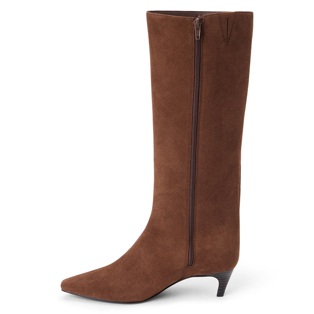 Vegan brown faux suede knee-high boot with a tall shaft, pointed toe, and slim brown kitten heel shown on a white background.