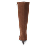 Vegan brown faux suede knee-high boot with a tall shaft, pointed toe, and slim brown kitten heel shown on a white background.
