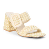 French vanilla raffia heeled sandal with a wide woven strap, oversized buckle detail, square toe, and block heel, shown on a white background.