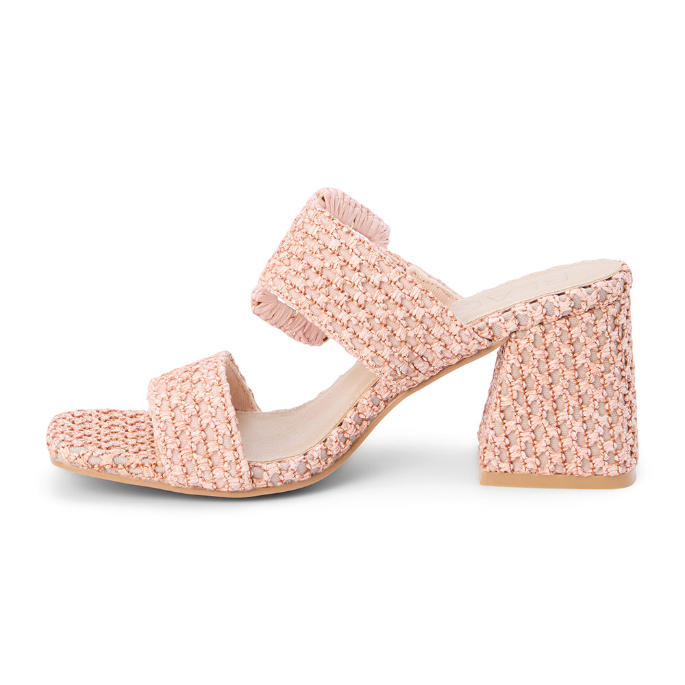 Blush raffia heeled sandal with a wide woven strap, oversized buckle detail, square toe, and block heel, shown on a white background.