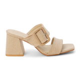 Sand textile heeled sandal with a wide textured strap, oversized buckle detail, square toe, and block heel, shown on a white background.