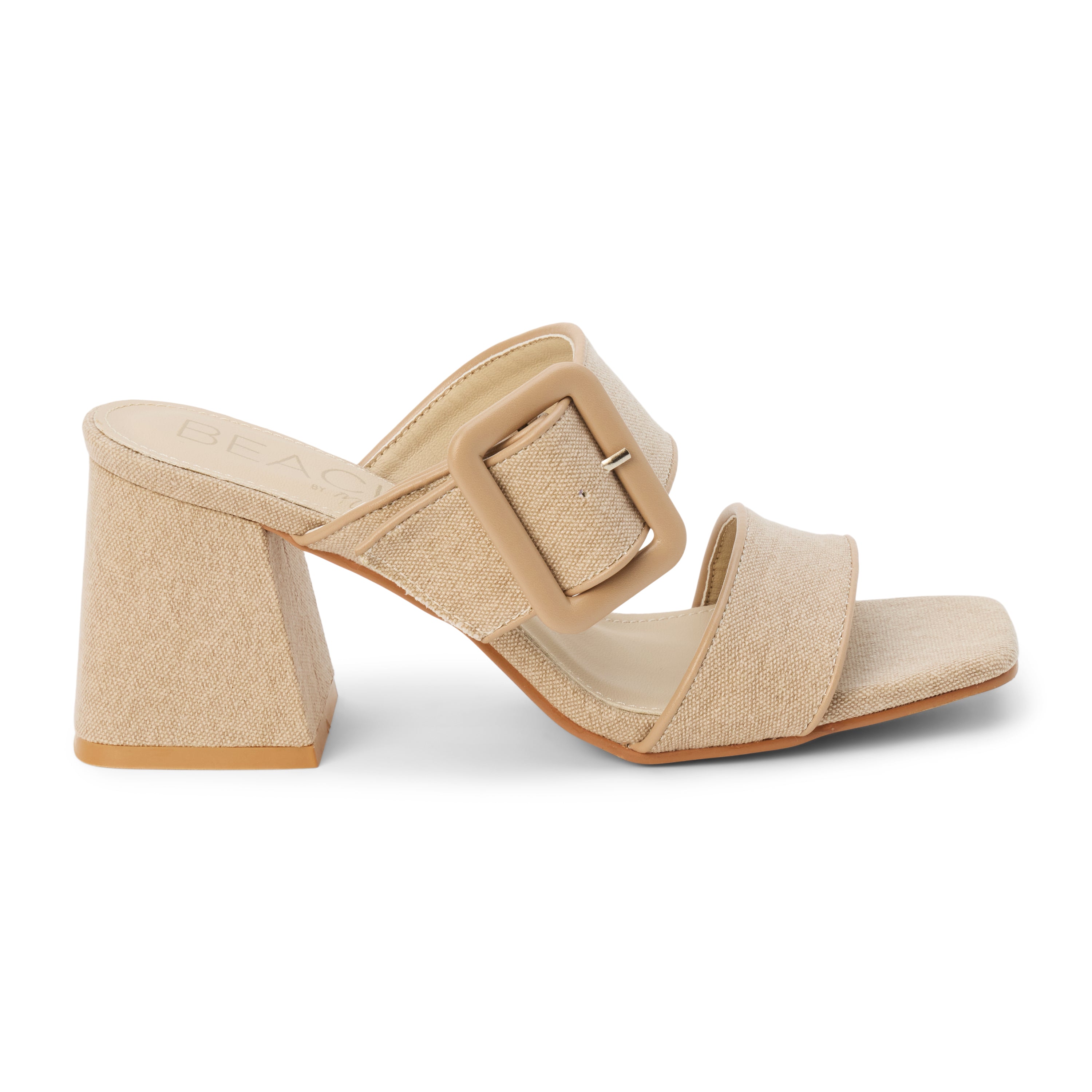 Sand textile heeled sandal with a wide textured strap, oversized buckle detail, square toe, and block heel, shown on a white background.