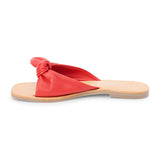 Red leather slide sandal with knotted strap and open toe shown on a white background.