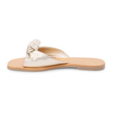 Gold leather slide sandal with knotted strap and open toe shown on a white background.