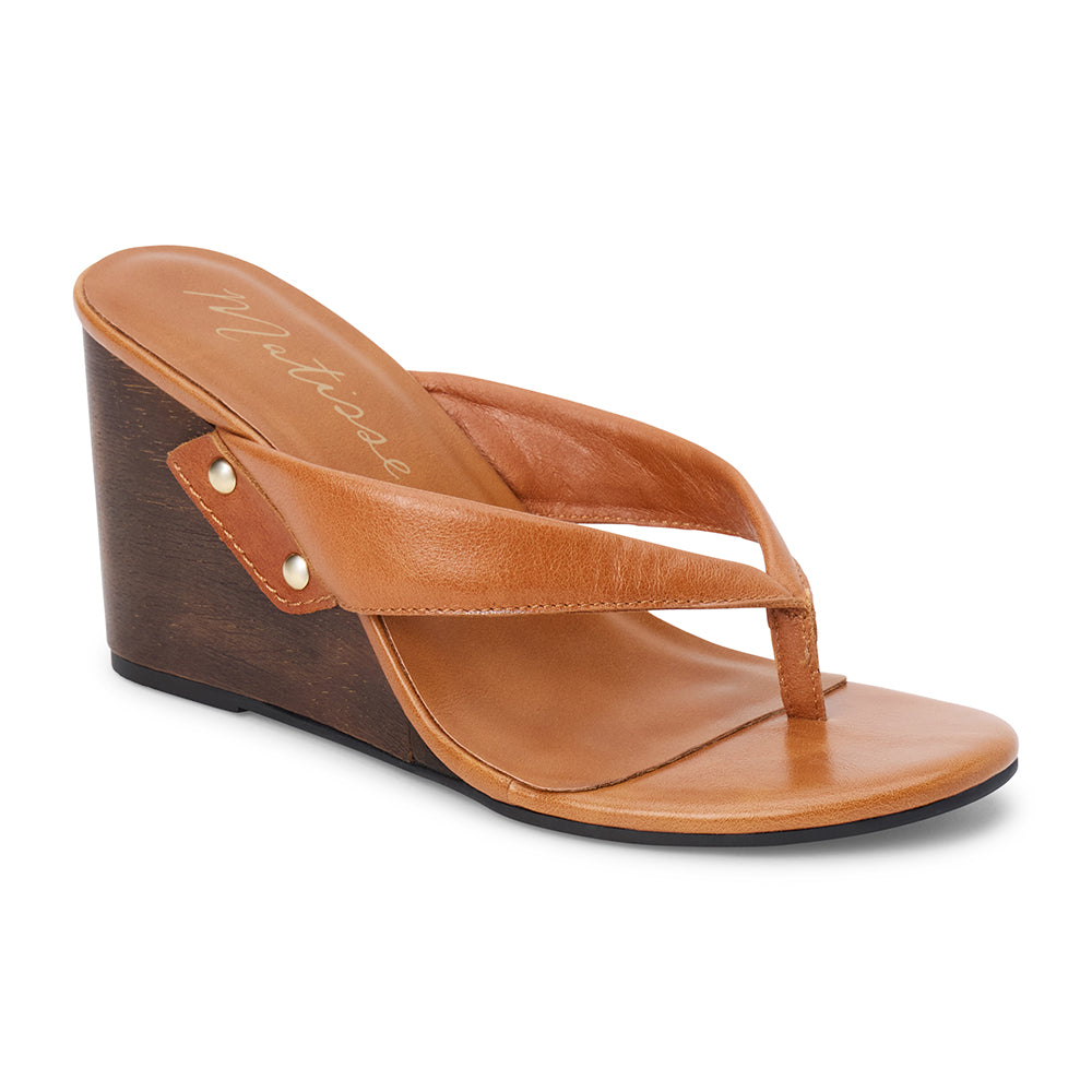 Brown leather wedge sandal with thong strap and wooden heel, shown on a white background.