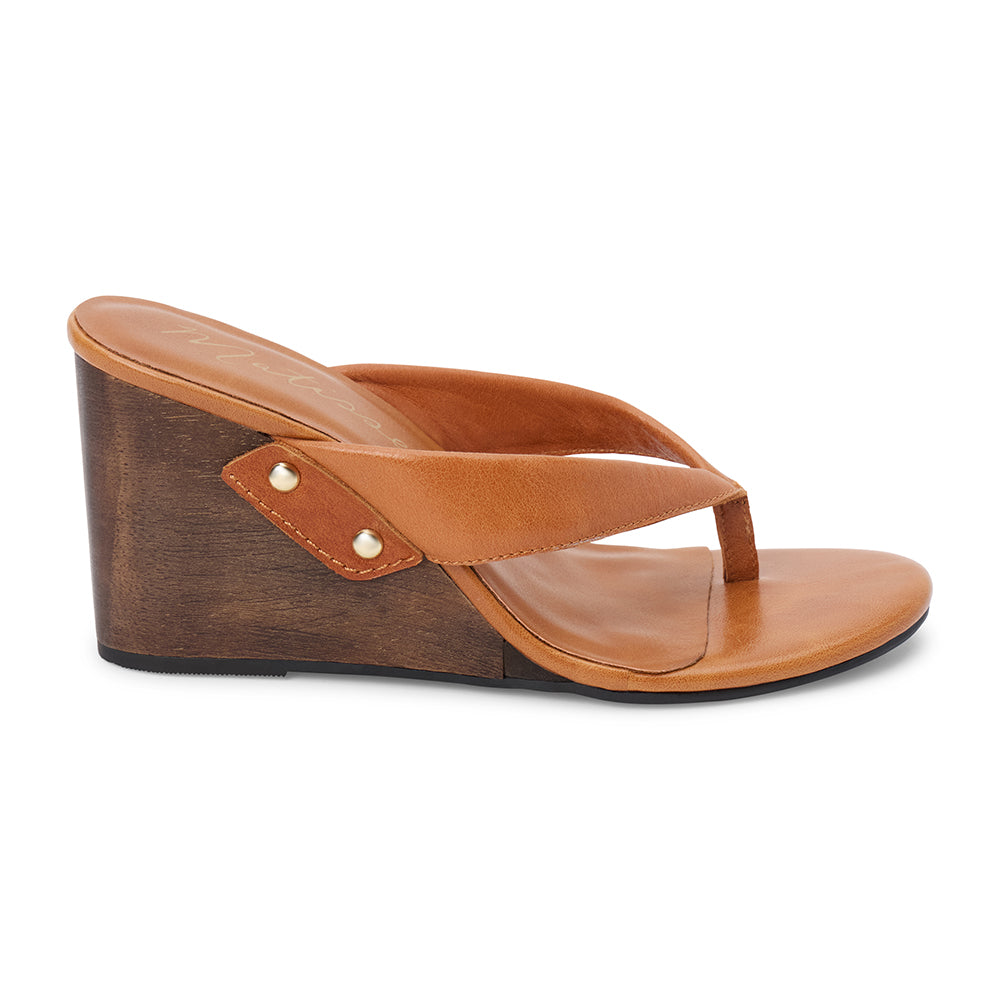 Brown leather wedge sandal with thong strap and wooden heel, shown on a white background.