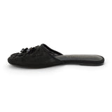 Black mesh mule with floral embellishments, slip-on design, low flat sole, and pointed toe, shown on a white background.