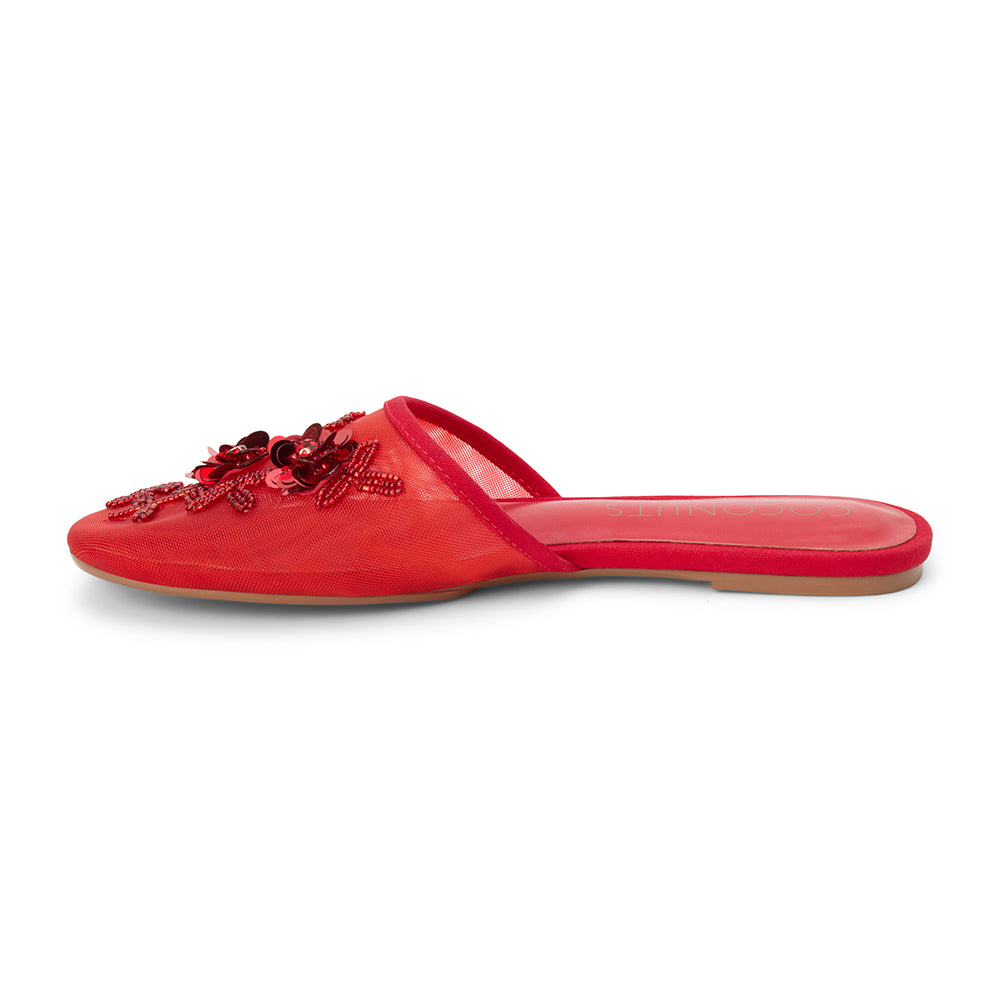 Red mesh mule with floral embellishments, slip-on silhouette, low flat sole, and pointed toe, shown on a white background.