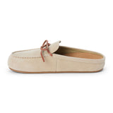 Tan suede clog with a moc-style apron toe, decorative leather bow, and backless silhouette shown on a white background.