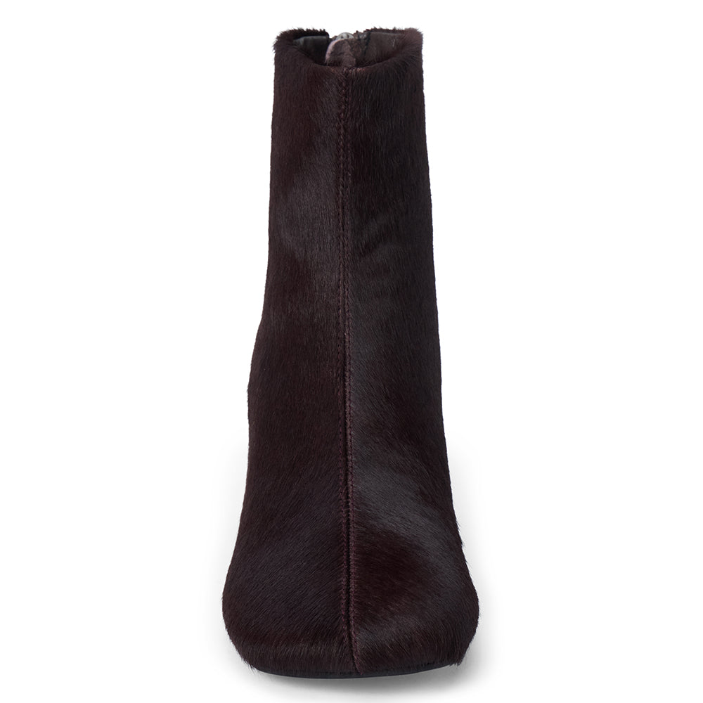 Dark purple cow hair ankle boot with a square toe, low flared heel, and side zipper shown on a white background.