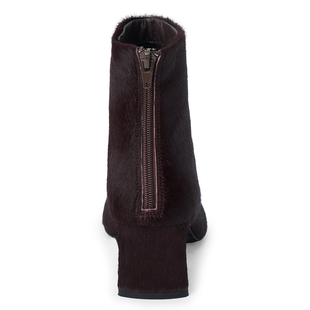 Dark purple cow hair ankle boot with a square toe, low flared heel, and side zipper shown on a white background.