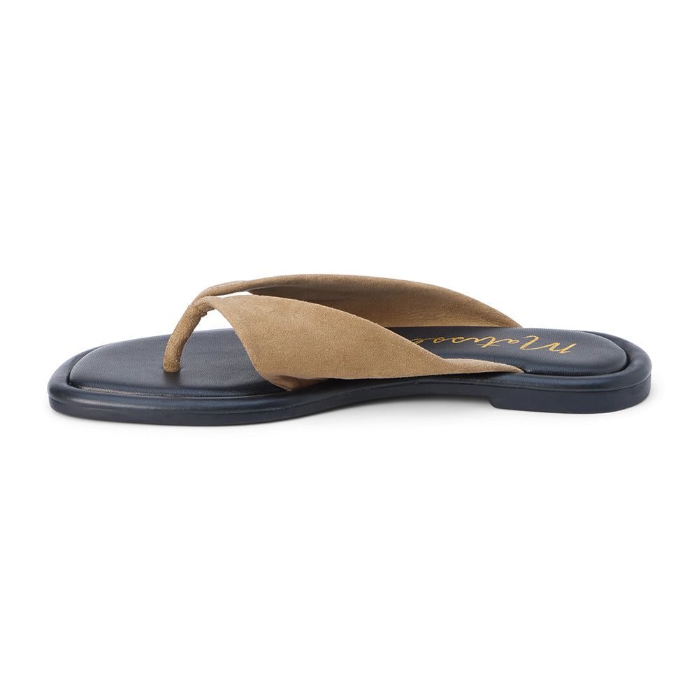 Tan suede flip flop sandal with wide strap and toe loop shown on a white background.