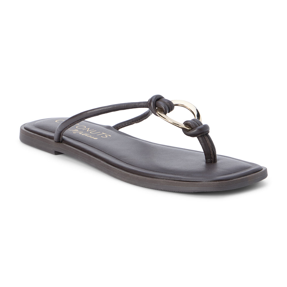 Brown leather thong sandal with metal ring detail and flat sole shown on a white background.