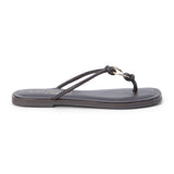 Brown leather thong sandal with metal ring detail and flat sole shown on a white background.