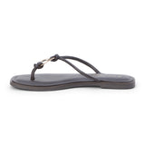 Brown leather thong sandal with metal ring detail and flat sole shown on a white background.