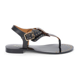 Black leather thong sandal with gold studs and buckle strap shown on a white background.
