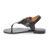 Black leather thong sandal with gold studs and buckle strap shown on a white background.