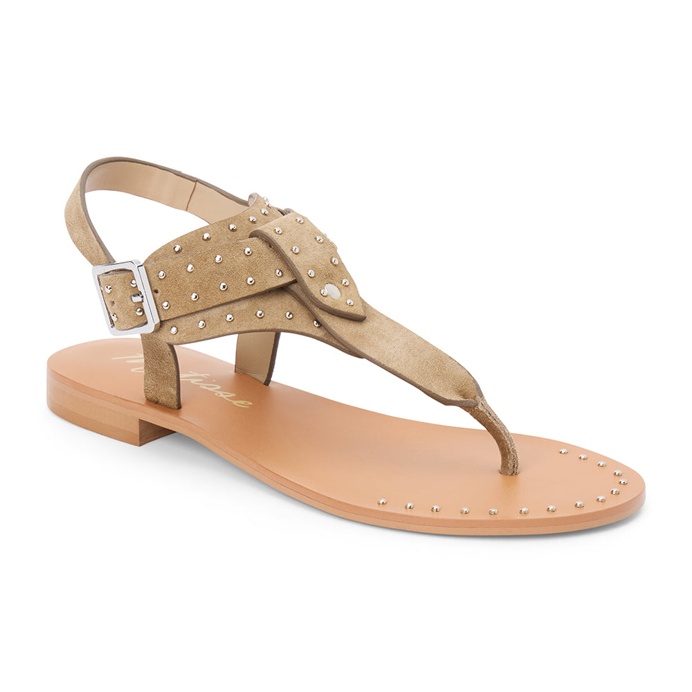 Tan suede thong sandal with gold studs and buckle strap shown on a white background.