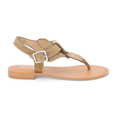 Tan suede thong sandal with gold studs and buckle strap shown on a white background.