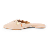 Tan suede mule with scalloped edges and decorative charms shown on a white background.