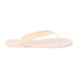Nude PVC jelly flip flop sandal with glossy straps, open toe, and flat sole, shown on a white background.