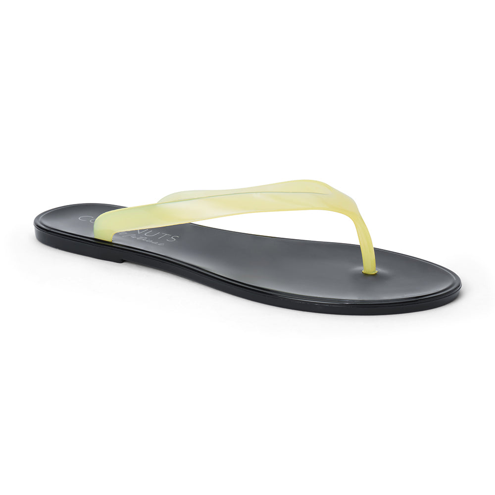 Light yellow and black PVC jelly flip flop sandal with translucent straps, open toe, and flat sole, shown on a white background.