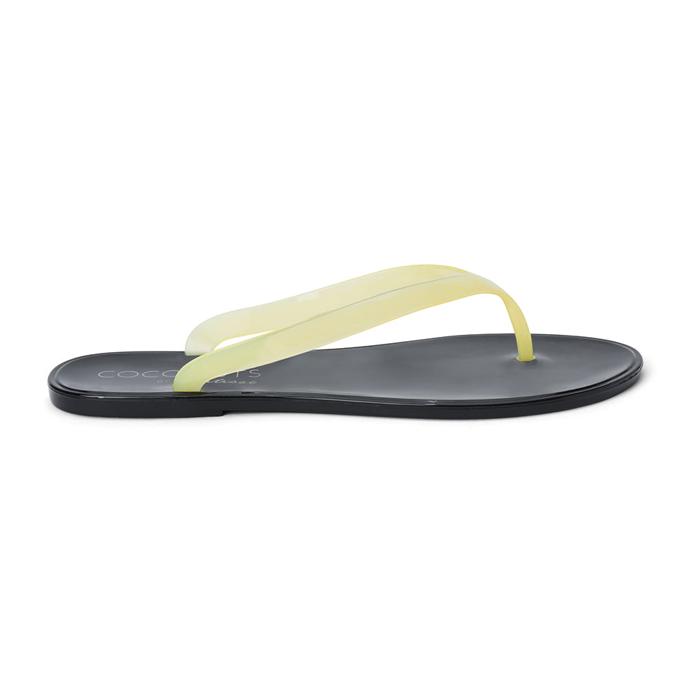 Light yellow and black PVC jelly flip flop sandal with translucent straps, open toe, and flat sole, shown on a white background.