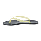 Light yellow and black PVC jelly flip flop sandal with translucent straps, open toe, and flat sole, shown on a white background.