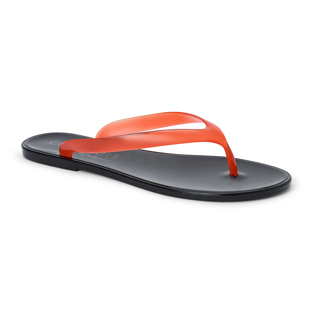 Red and black PVC jelly flip flop sandal with translucent straps, open toe, and flat sole, shown on a white background.