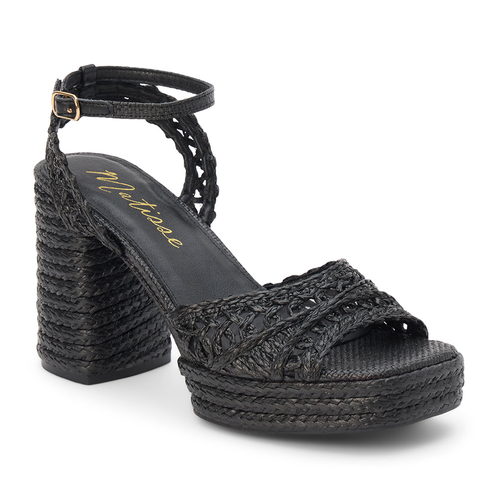 Black raffia platform sandal with woven straps, ankle buckle, and block heel, shown on a white background.