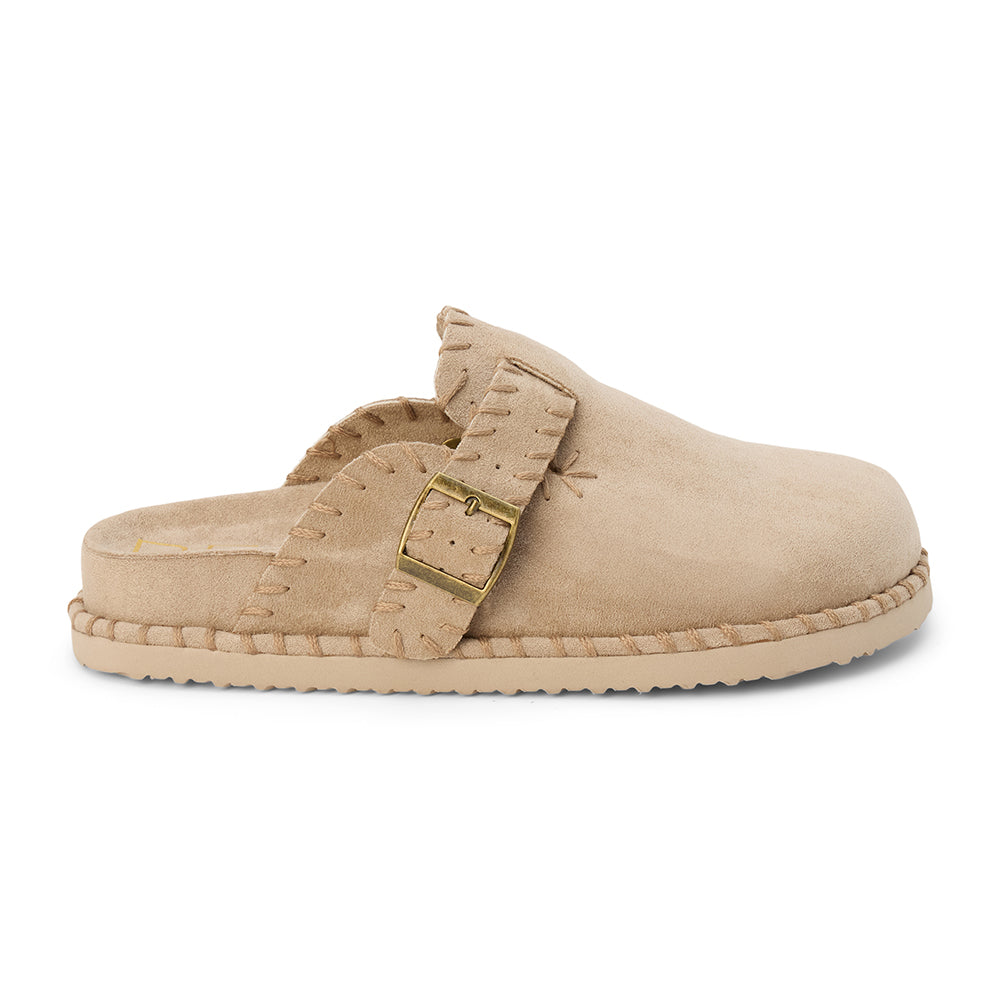 Light beige slip-on clog with a closed toe, stitched edges, and an adjustable buckle strap, shown in a side profile on a white background.
