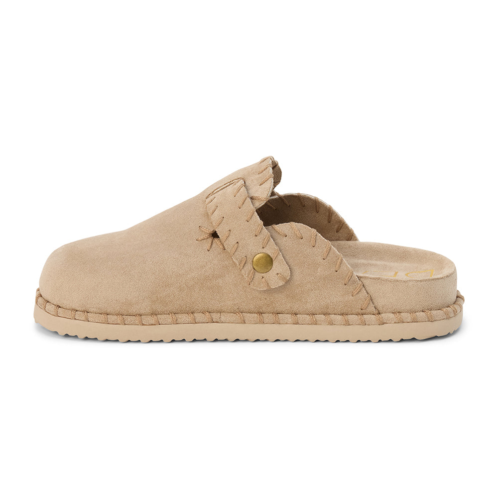 Light beige slip-on clog with a closed toe, stitched edges, and an adjustable buckle strap, shown in a side profile on a white background.