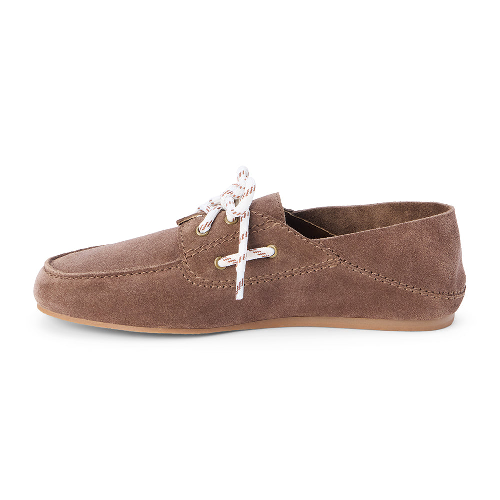 Light brown suede moc-toe boat shoe with lace-up detail and low-profile sole, shown on a white background.