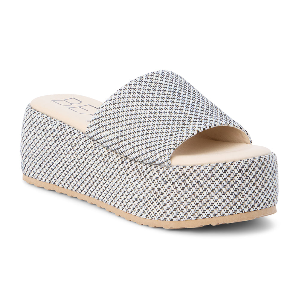 White and black jute platform slide sandal with a wide woven strap and flatform sole, shown on a white background.