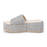 White and black jute platform slide sandal with a wide woven strap and flatform sole, shown on a white background.