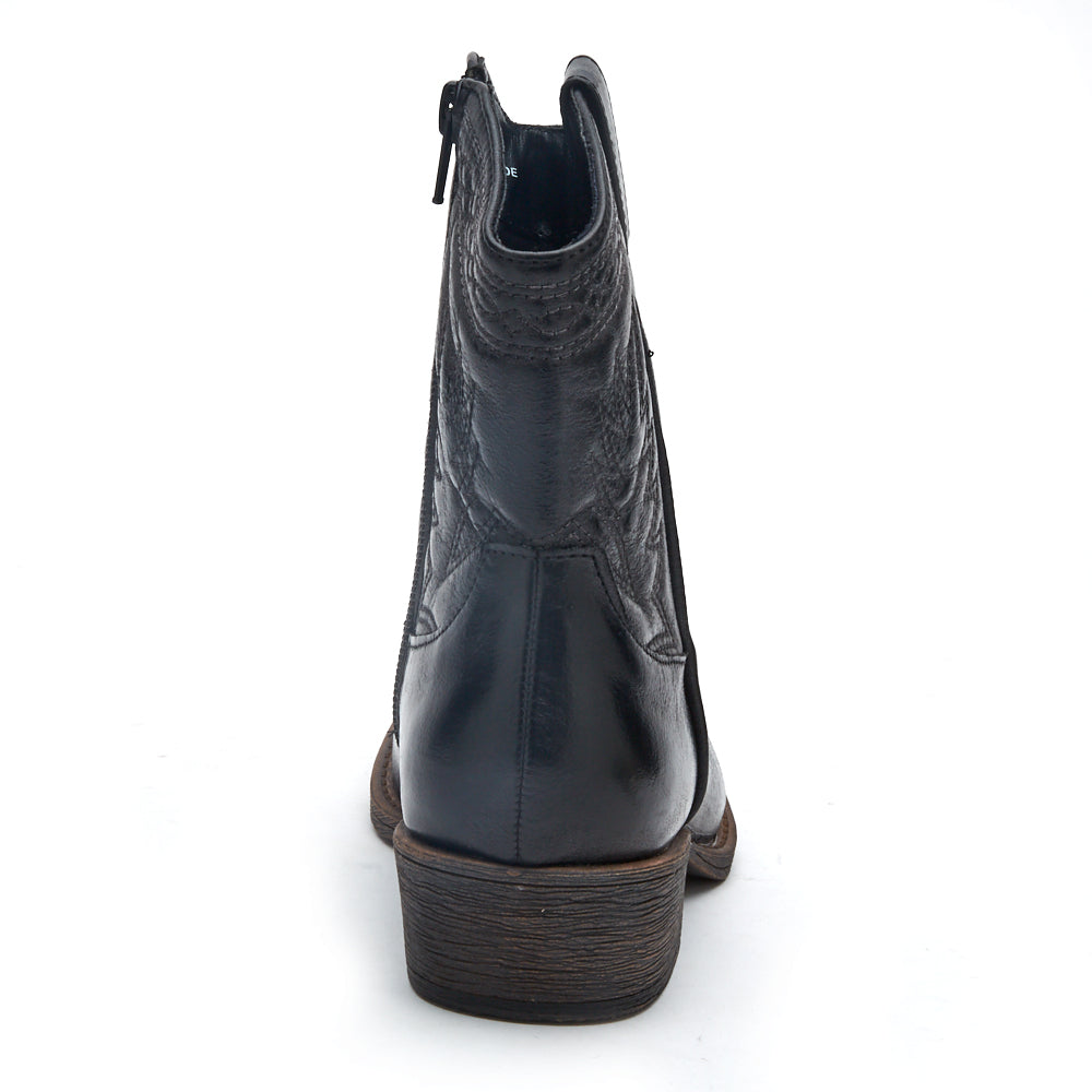 Vegan black textile Western boot with decorative stitching, a pointed toe, distressed finish, and stacked block heel shown on a white background.