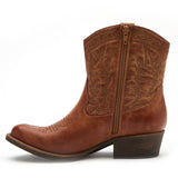 Vegan brown textile Western boot with decorative stitching, a pointed toe, distressed finish, and stacked block heel shown on a white background.